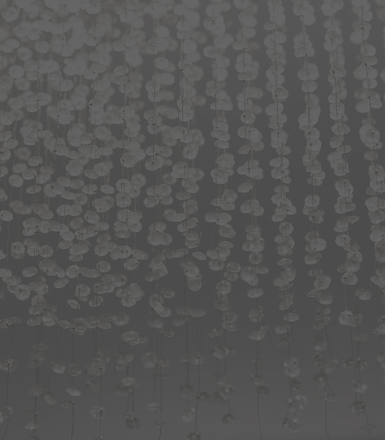 Beaded curtain with a dark background.